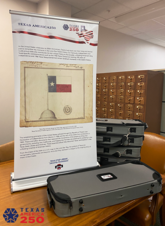 Photo of single panel of exhibit standing on table, with travel cases for other four panels stacked nearby Photo of single panel of exhibit standing on table, with travel cases for other four panels stacked nearby